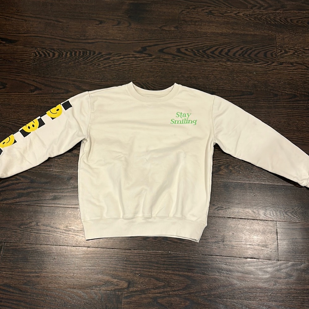 A crewneck with a smiley face from FREEZE